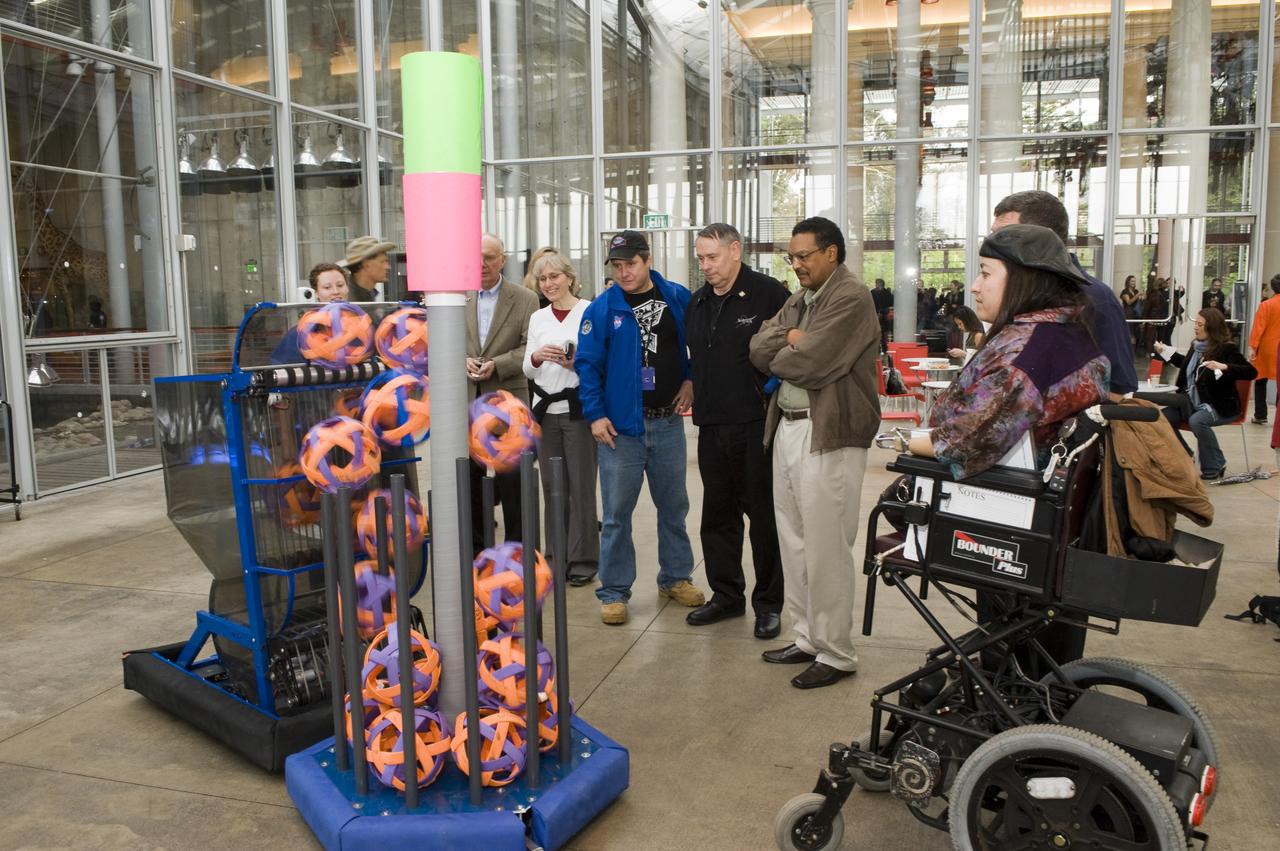 Yuri's Night 2009 held at the California Acaemy of Sciences in San Francisco, California from left in blue NASA jacket Mark Leon, Pete Worden, Lew Braxton, and Dana Bolles of Ames look over the the NASA Ames robotics team the Cheesy Poofs robot)