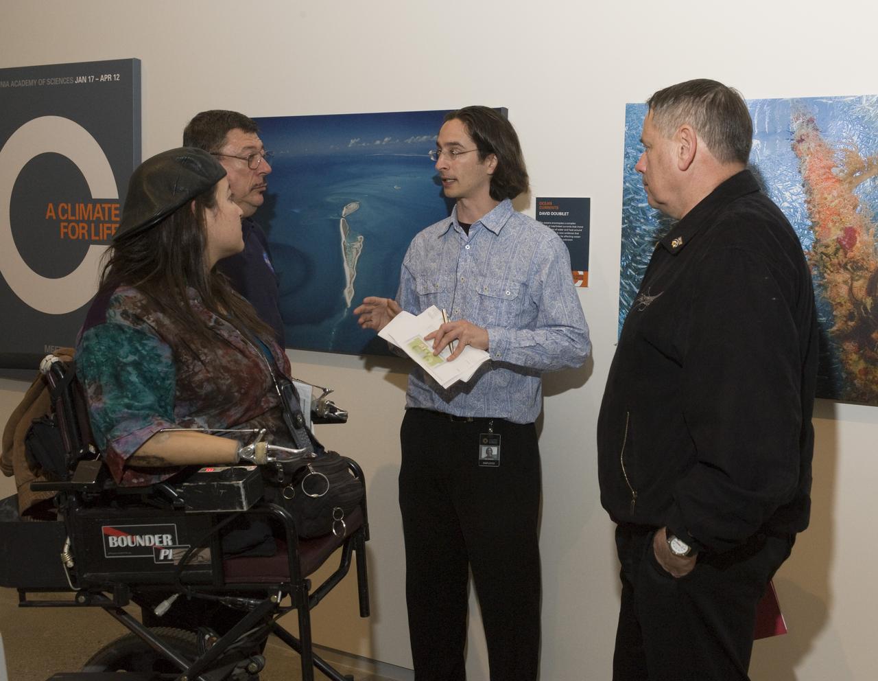 Yuri's Night 2009 held at the California Acaemy of Sciences in San Francisco, California Ames's (l-r) Dana Bolles and Davis Morse speak with a news person as Peter Worden Ames Center Director looks on)