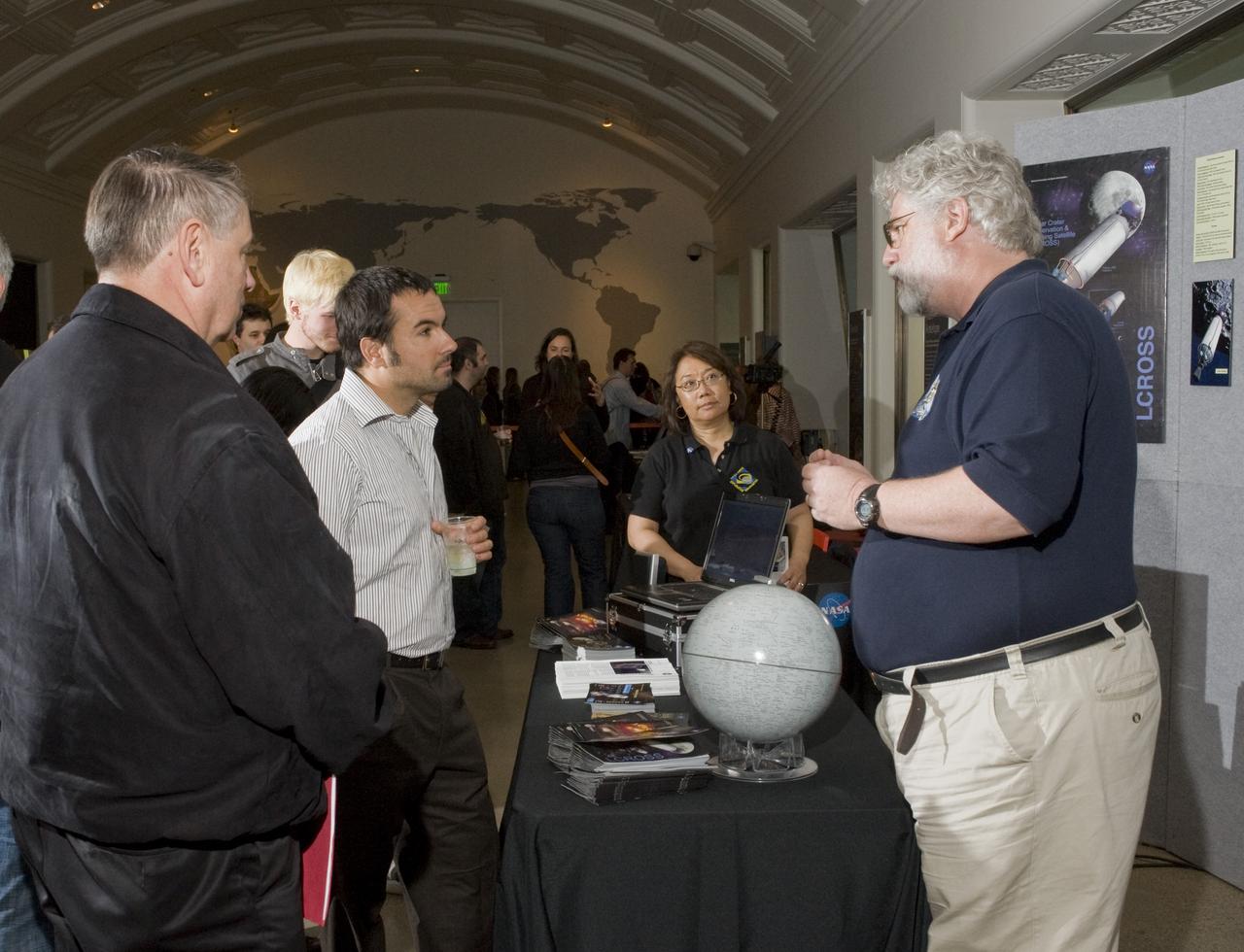 Yuri's Night 2009 held at the California Acaemy of Sciences in San Francisco, California Ames Center Director Pete Worden listens in on Brian Day, Planners,  part of the Ames LCROSS team explain the intent of the mission.