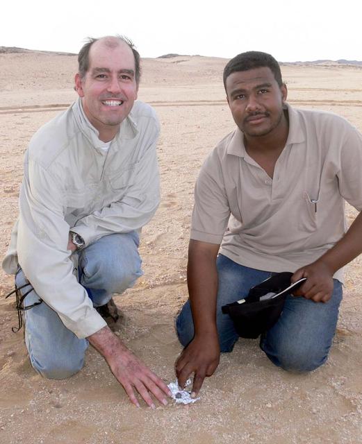 An SUV-sized Asteroid 2008TC# Impacts on October 7, 2008 in the Nubian Desert, Northern Sudan: Dr. Peter Jenniskens, NASA/SETI joined Muawia Shaddas of the University of Khartoum in leading an expedition on a search for samples.  (first find)  Photo Credit: NASA/SETI/P. Jenniskens