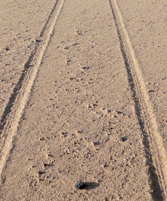 An SUV-sized Asteroid 2008TC# Impacts on October 7, 2008 in the Nubian Desert, Northern Sudan: Dr. Peter Jenniskens, NASA/SETI joined Muawia Shaddas of the University of Khartoum in leading an expedition on a search for samples.  (meteorite-brick-reenactment)   Photo Credit: NASA/SETI/P. Jenniskens