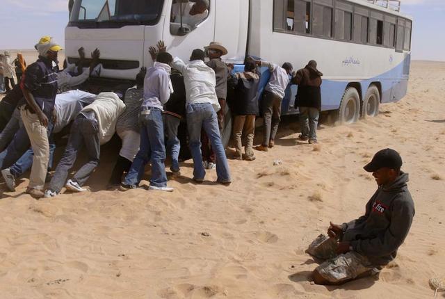 An SUV-sized Asteroid 2008TC# Impacts on October 7, 2008 in the Nubian Desert, Northern Sudan: Dr. Peter Jenniskens, NASA/SETI joined Muawia Shaddas of the University of Khartoum in leading an expedition on a search for samples.  (meteorite find - bus gets stuck)  Photo Credit: NASA/SETI/P. Jenniskens