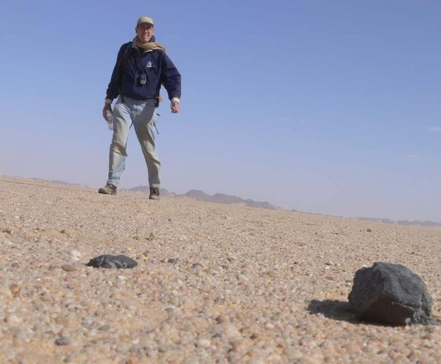 An SUV-sized Asteroid 2008TC# Impacts on October 7, 2008 in the Nubian Desert, Northern Sudan: Dr. Peter Jenniskens, NASA/SETI joined Muawia Shaddas of the University of Khartoum in leading an expedition on a search for samples.  Peter Jenniskens meteorite.  Photo Credit: NASA/SETI/P. Jenniskens