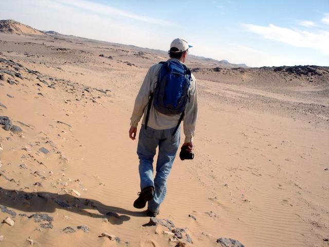 An SUV-sized Asteroid 2008TC# Impacts on October 7, 2008 in the Nubian Desert, Northern Sudan: Dr. Peter Jenniskens, NASA/SETI joined Muawia Shaddas of the University of Khartoum in leading an expedition on a search for samples. Peter Jenniskens walking Photo Credit: NASA/SETI/P. Jenniskens