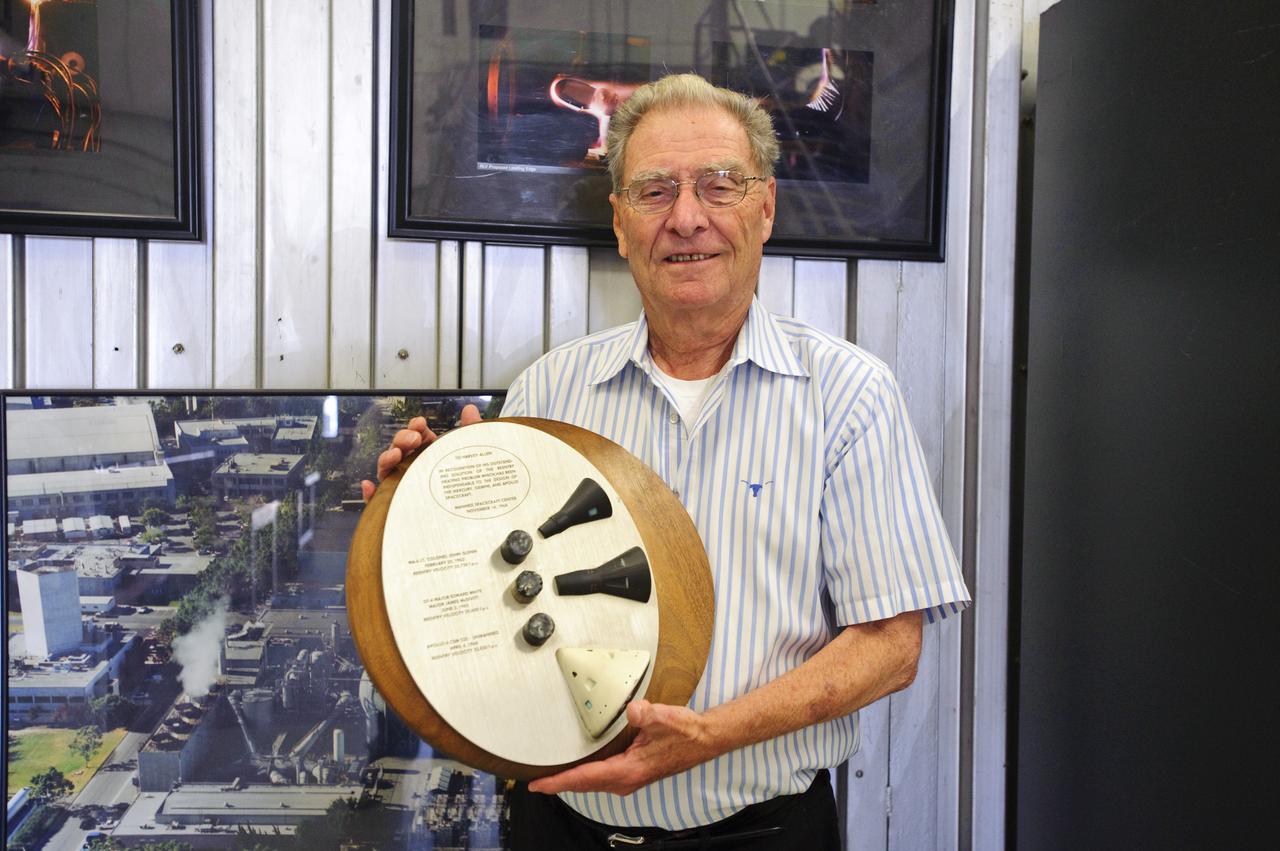 John W. 'Jack Boyd holds a plaque presented to Harvey Allen in recognition of his outstanding solution of the reentry heating problem which has been indispensable to the design of the Mercury, Gemini, and Apollo spacecraft  (Manned Spacecraft Center, November 14, 1968) Plaque contains samples of tested materials and models of spacecraft.