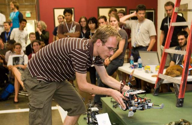 International Space University (ISU - 2009) students participated in a Robotic Competition at NASA'A Ames Research Center, Moffett Field, Calif. This panel featured astronauts from four different space agencies with different areas of expertice and diverse perspectives. Thibault DeLeu, ISU SSP09 student, takes his team's robot from the stage before placing it on the Robotic Competition's obstacle course.