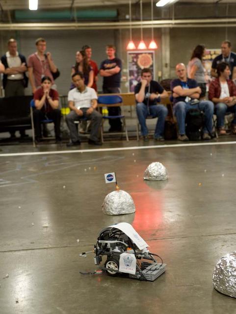 International Space University (ISU - 2009) students participated in a Robotic Competition at NASA'A Ames Research Center, Moffett Field, Calif. This panel featured astronauts from four different space agencies with different areas of expertice and diverse perspectives. A student-built robot rolls across the obstacle course. A student-built robot rolls across the obstacle course.