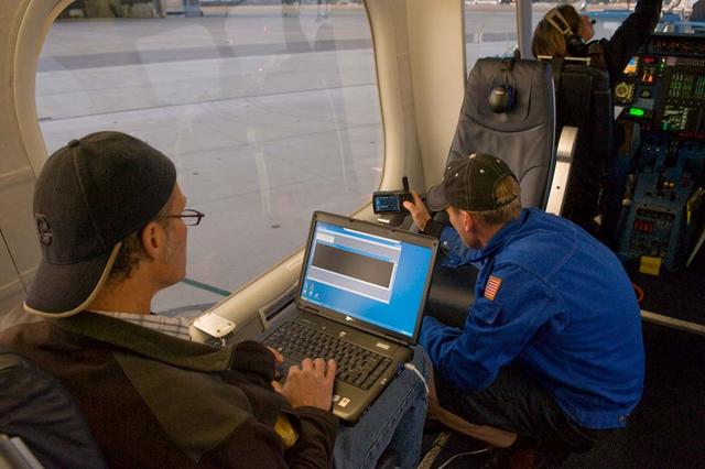 NASA Conducts Airborne Science Aboard Zeppelin Airship: equipped with two imaging instruments enabling remote sensing and atmospheric science measurements not previously practical. Cabin view of Instrument Operator Steve Dunagan, NASA Ames, Pilot Katharine 'Kate' Board, (left) and Crew Chief Matthew Kilkerr (in flight suit) preforming pre-flight checkouts.