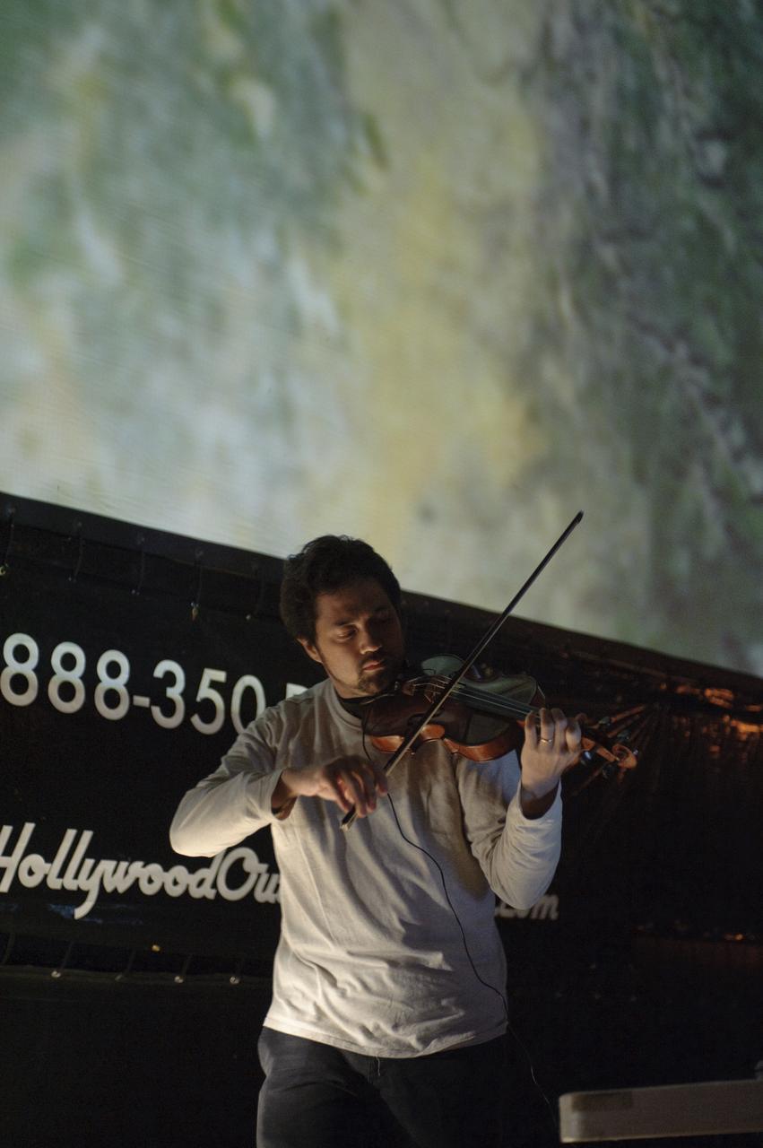 LCROSS Impact Night: Public invited to all night event are watching the mission unfold from a large screen on Shenandoah Parade Grounds at NASA Ames Research Center, Moffett Field Calif. while listening to the music of Kenji Williams on violin.