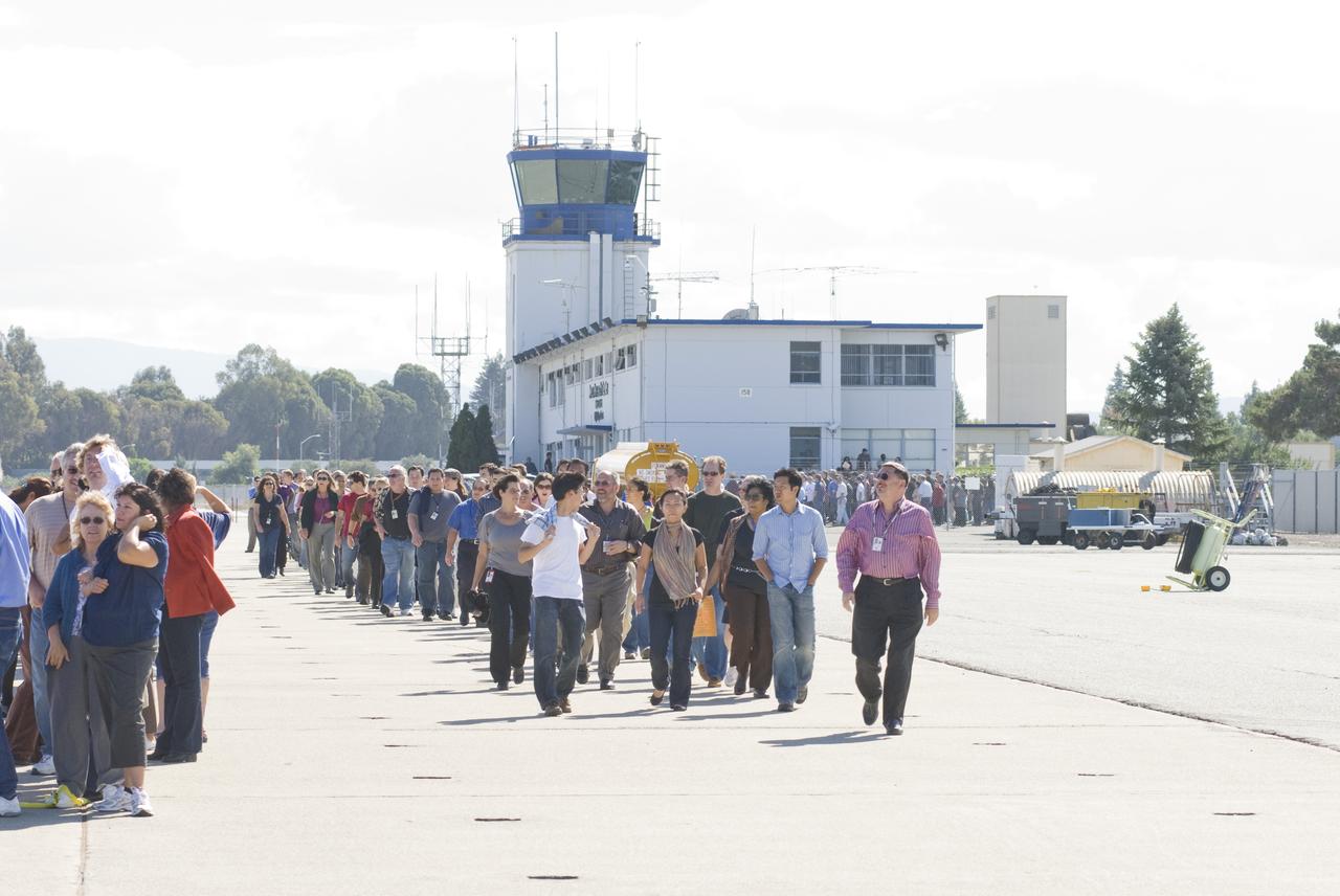 Ames 70_year picture day on Flight line. David Morse leads the the staff to their places in the line to keep the numbers uniform.