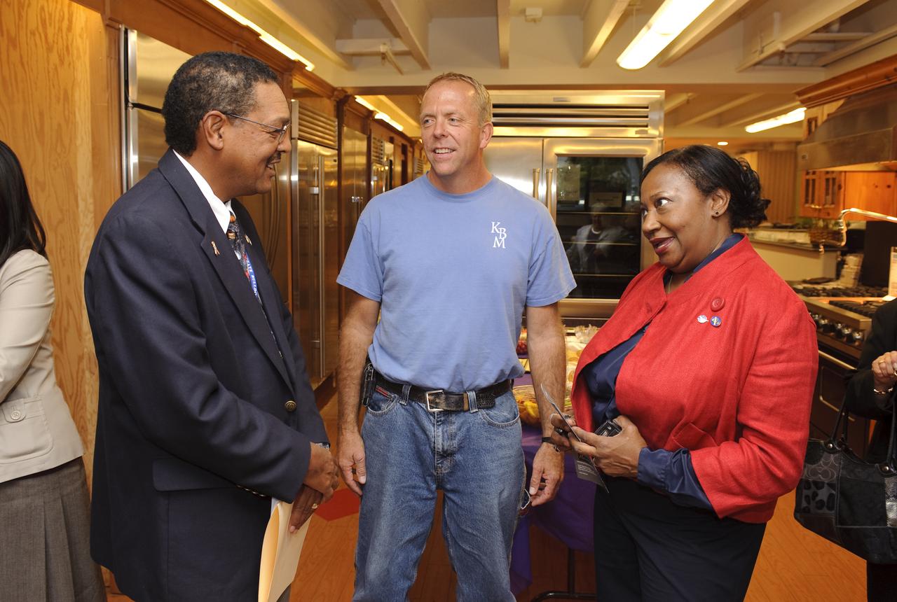 Ames 70 Year Anniversary Exhibit in downtown Mountain View, California. Grand Opening at Meyer Appliance, Castro Street. Left to right, Lewis Braxton III, Ames Deputy Center Director, Mr Meyer III, and Sheila Johnson, Ames awaiting the opening ceremony.