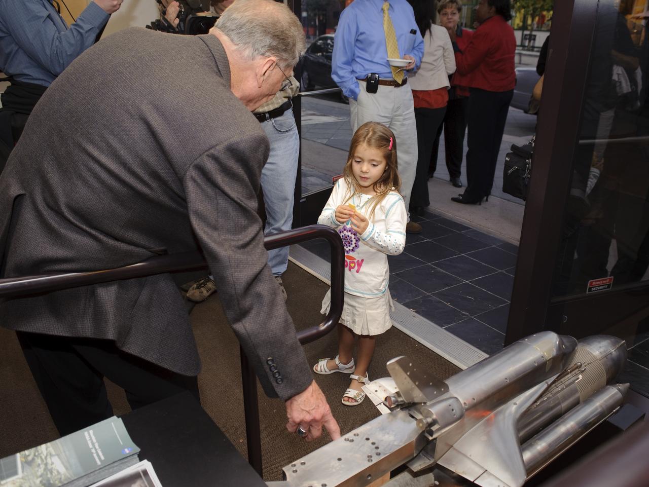 Ames 70 Year Anniversary Exhibit in downtown Mountain View, California. Grand Opening at Meyer Appliance, Castro Street. Jack Boyd, Ames educates the younger generation at the exhibit on wind tunnel models