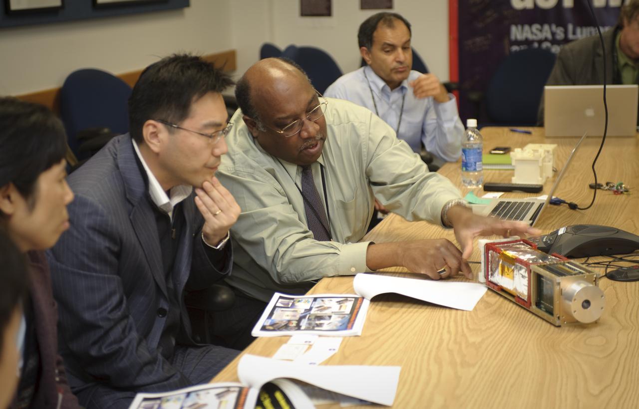 Korean High Level Delegation Visit Ames Certer Director and various Senior staff: John Hines, Ames Center Chief Technologist (middel left) explains PharmaSat (small Satellites) to Soon-Duk Bae, Deputy Director, Big Science Policy Division, Ministry of Educaiton, Science Technology, Young-Mok Hyun, Deputy Director, Space Development Division, Ministry of Educaiton, Science Technology, Seorium Lee, Senior Researcher, International Relations Korea Aerospace Research Institute. Unkonw person at the end of table.