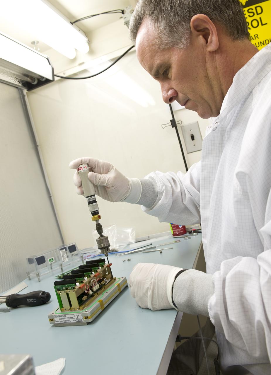 TROPI-2; Assembly of flight hardware with Prepared Experiment Containers loaded with seeds in EMCS (European Modular Cultivation System) Lab, N-236. Flight hardware will be hand carried to KSC for loading on STS-130 Shuttle mission. David Leskovsky works on the assembly.