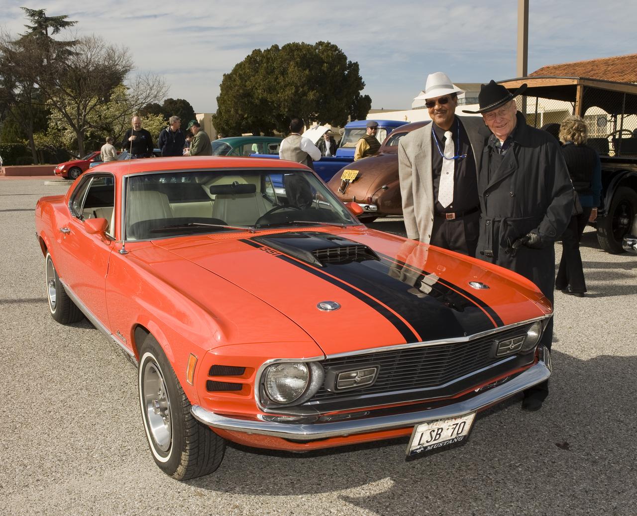 Ames 70th Anniversary Turn Back the Clock Day with antique Class Cars and Classic Car parade around the center. Lewis Braxton III, Ames Deputy Center Director and Jack Boyd, Ames Historian pose by Lew's Mustang before leading the parade.