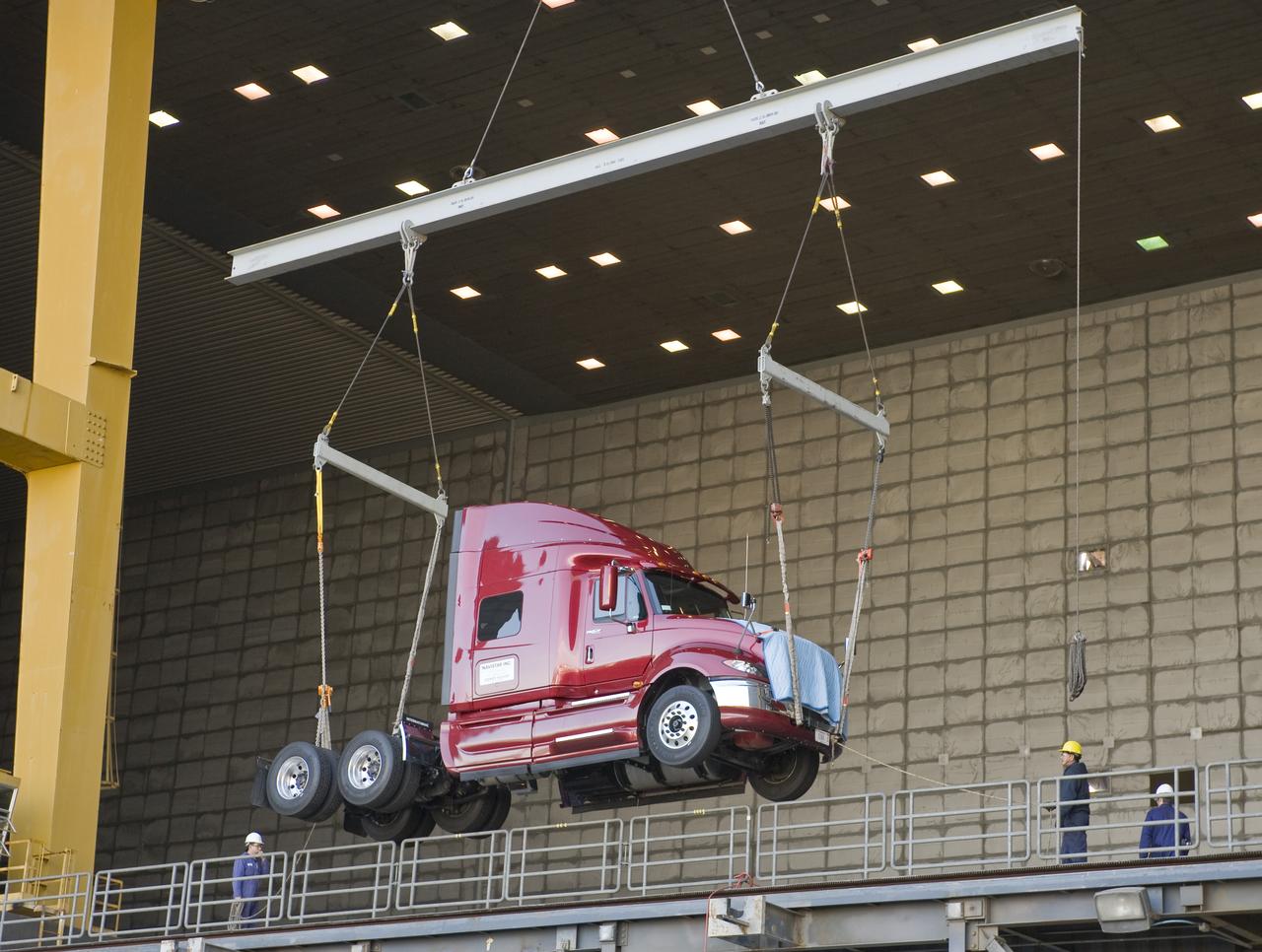 Lawrence Livermore National Labs (LLNL), Navistar and the Department of Energy conduct tests in the NASA Ames National Full-scale Aerodynamic Complex 80x120_foot wind tunnel. The LLNL project is aimed at aerodynamic truck and trailer devices that can reduce fuel consumption at highway speed by 10 percent. Cab being lifted into the tunnel.