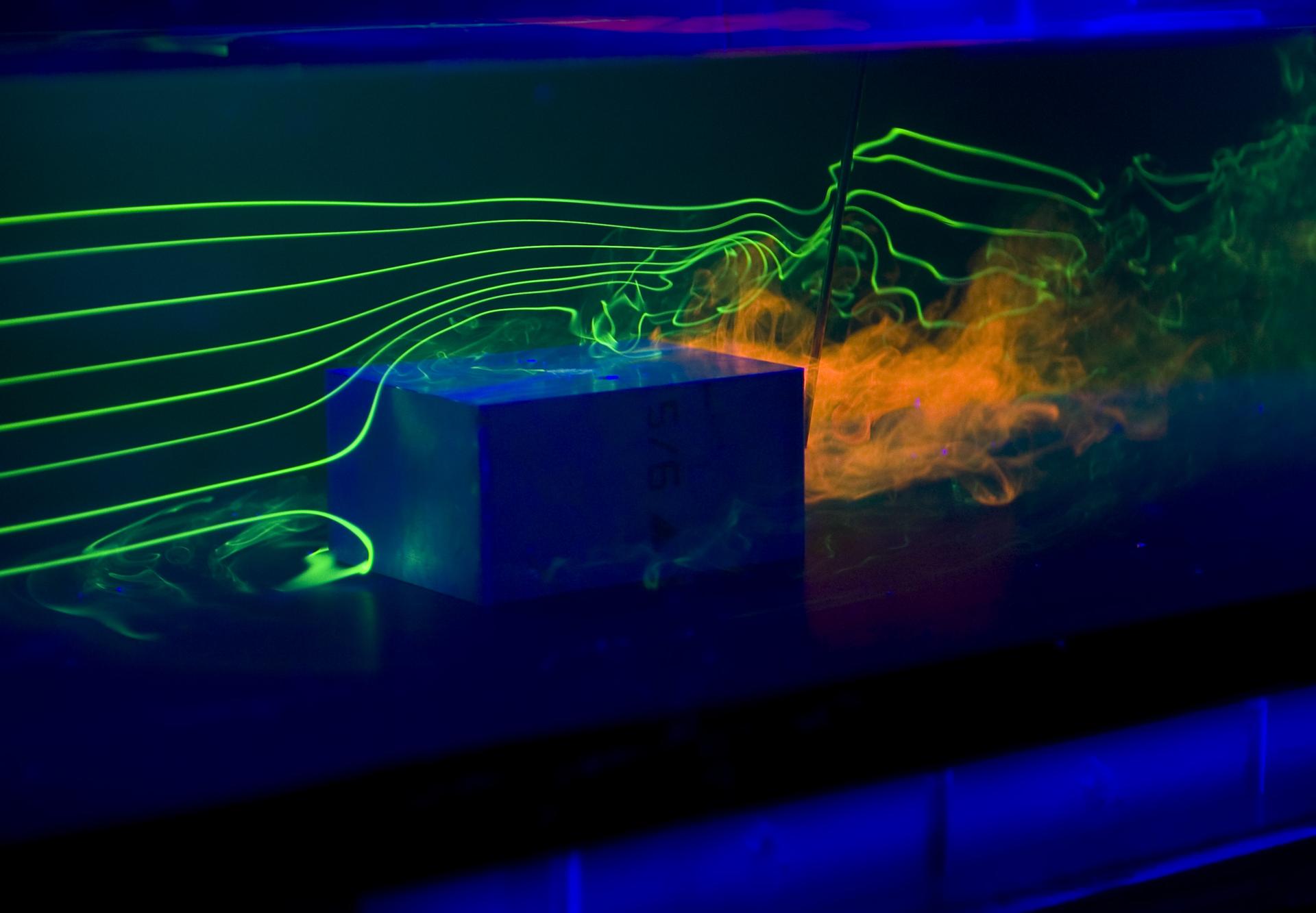 box in water chamber with lasers and smoke around it