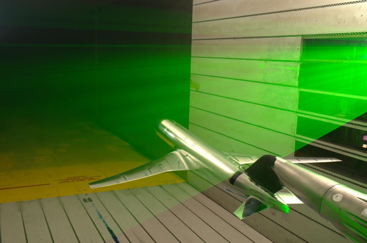 Common Research Model (CRM) Test t11-0216 in the NASA Ames 11x11_foot Transonic Wind Tunnel with PIV laser sheet over model. (3D PIV Particle Image Velosymetry Equipment)