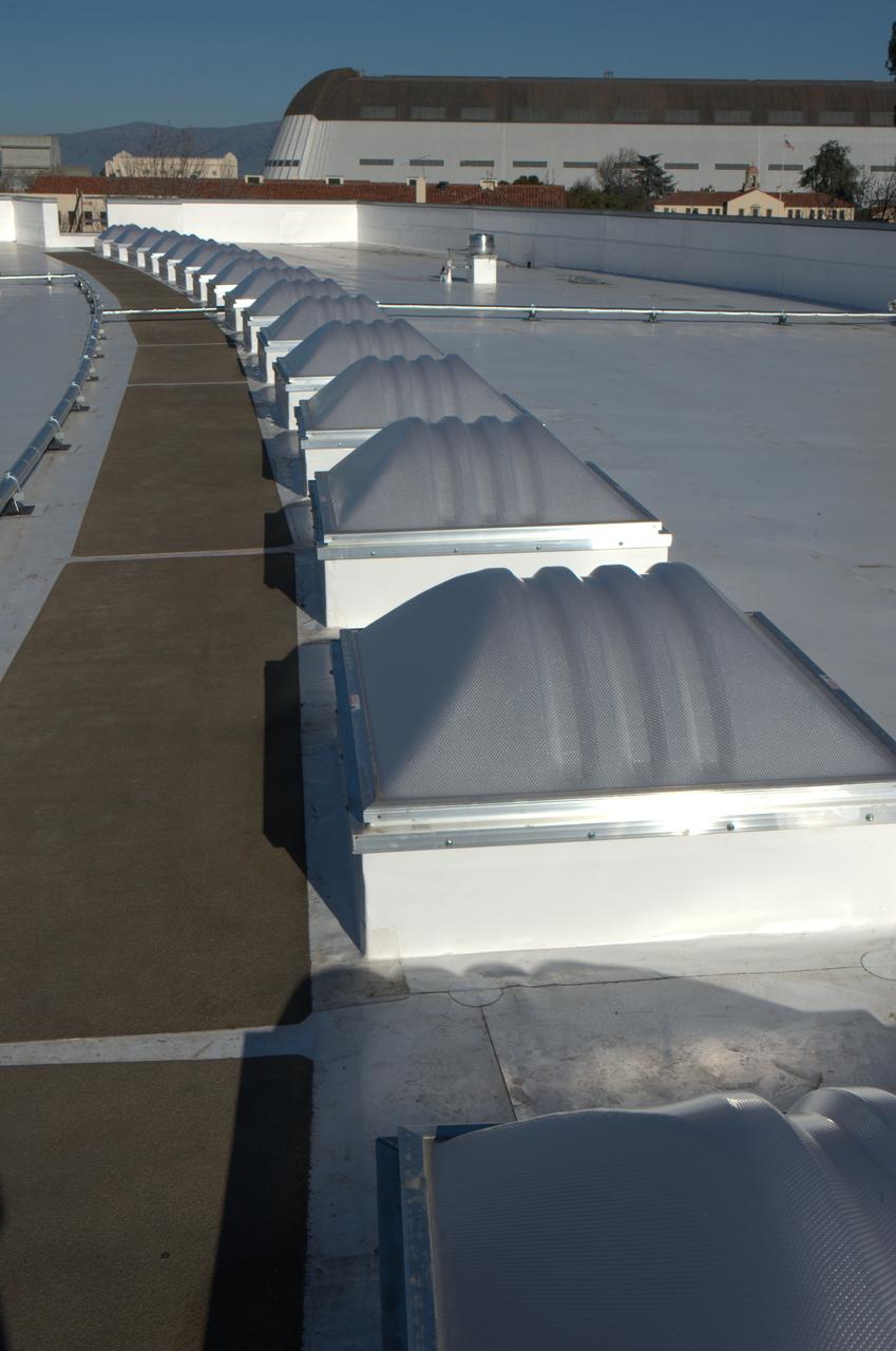 Construction of the new NASA Ames Green Building dubbed Sustainability Base located on the Ames Research Center campus at Moffett Field, CA. Skylight and piping on roof, Hangar One in background.