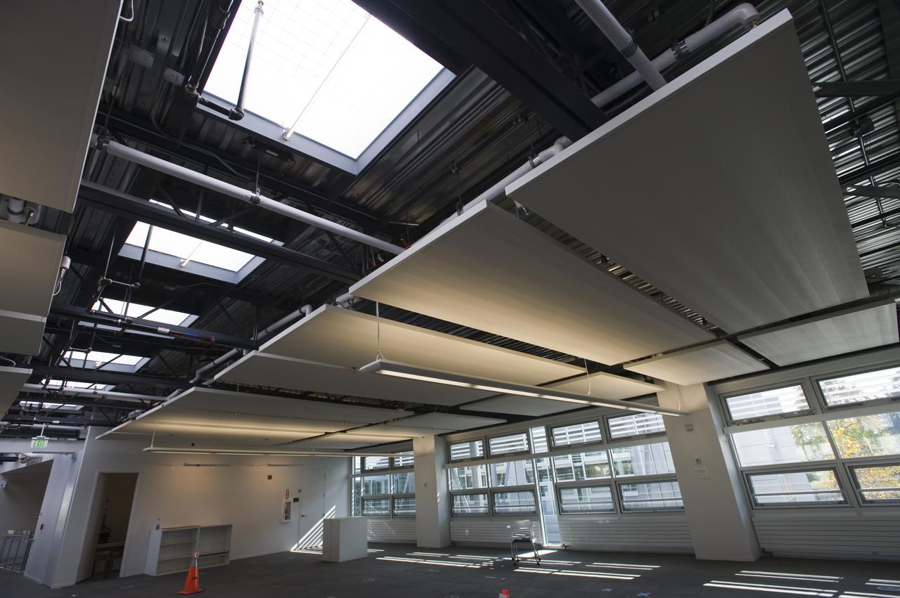 Construction of the new NASA Ames Green Building dubbed Sustainability Base located on the Ames Research Center campus at Moffett Field, CA. interior view as cubicles are being set up and open spaces arranged. skylights, artifical lighting and windows