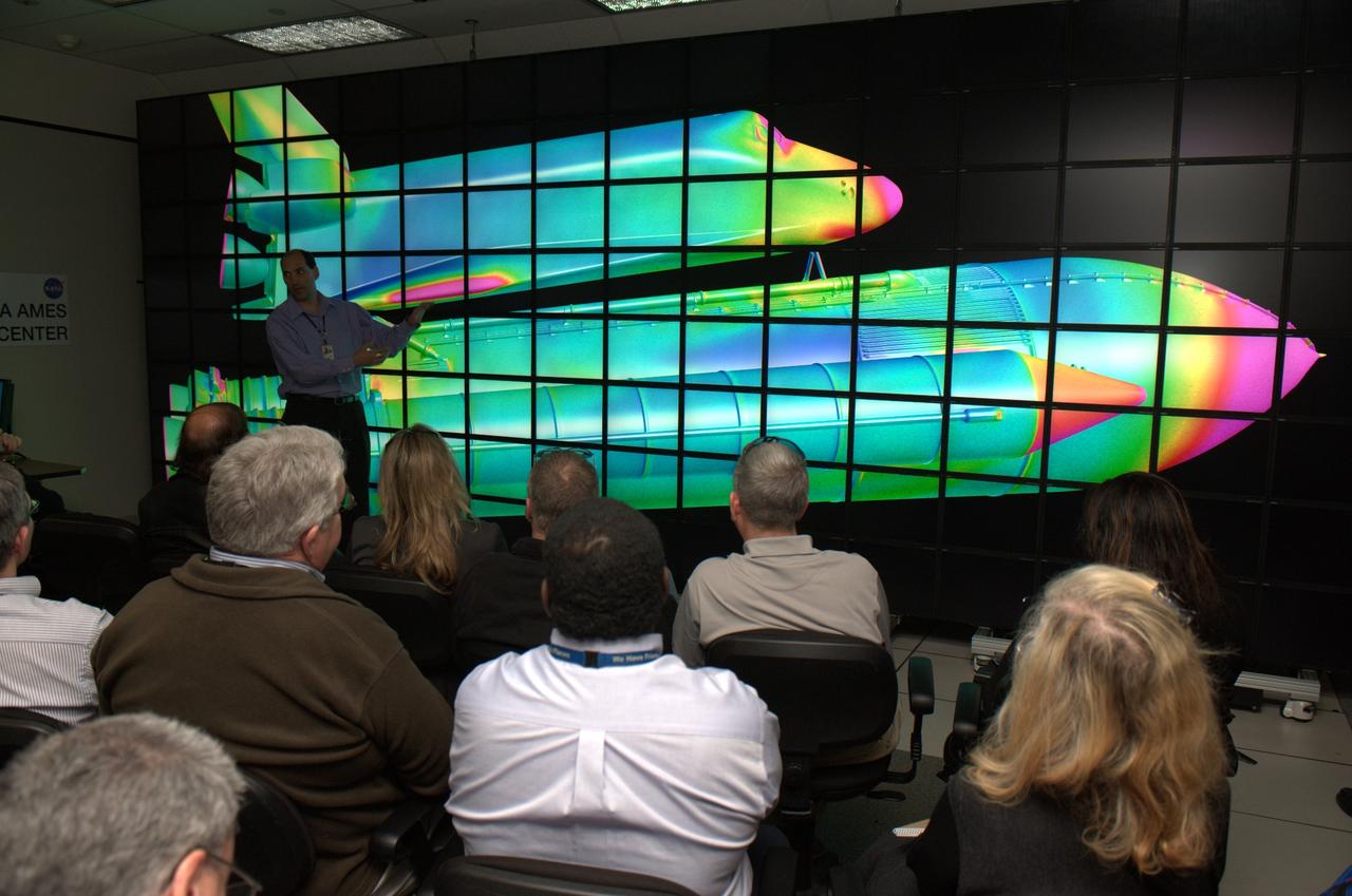 NAS Facility Hyperwall 2 visit and tour: HQ Review Committee on Facility & Real Property. Showing on Hyperwall is the Space Shuttle.