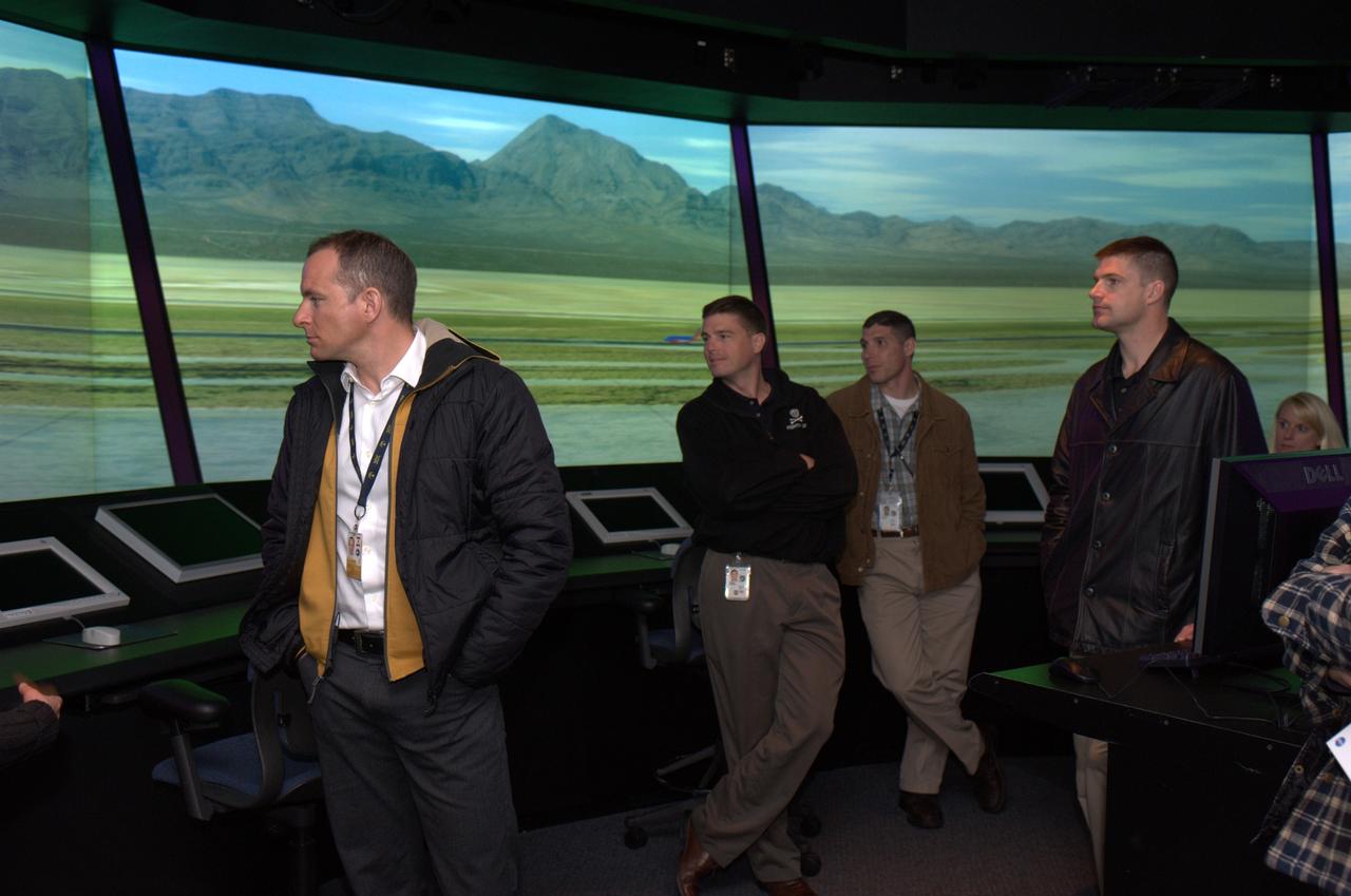 The 14 member 2009 class of NASA astronauts, Japan Aerospace Explortion Agency (JAXA) astronauts and Canadian Space Agency astronauts visit  Ames Research Center. From left to right David Saint-Jacques (CSA) Gregory (Reid) Wiseman, Michael Hopkins, Jeremy Hanson during a tour of the Future Flgiht Central (FFC) Simulator.