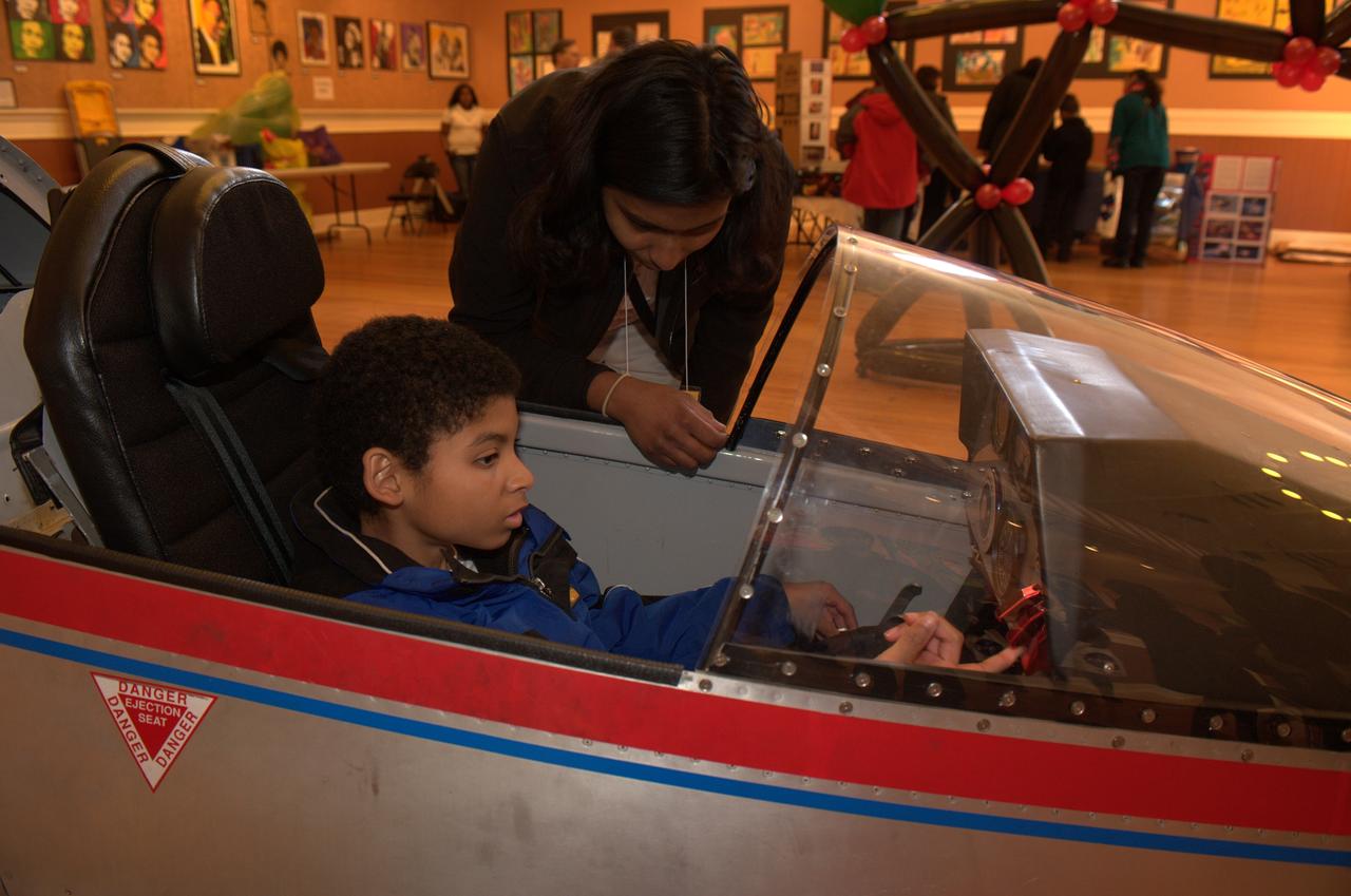 10th Anniversary of Reachout for the Rainbow after School Science Festival highlighting NASA Ames and the Traveling Space Museum exhibits and activities at the South San Francisco Bayview Opera House. Stephen Horsley gets a close up look at the cockpit of one the models provided by the Traveling Space Museum (TCS).     photo release on file