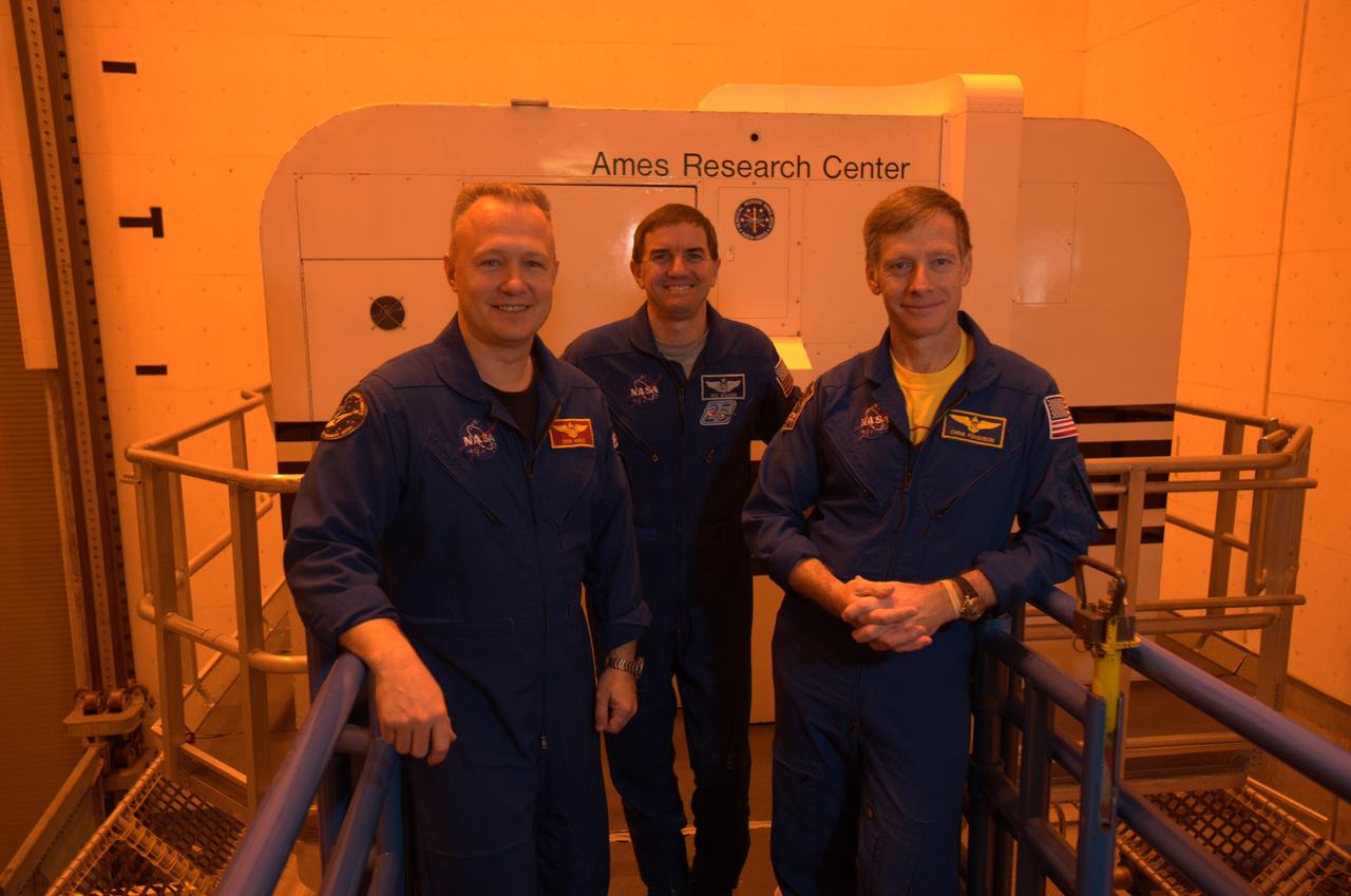 STS-135 astronaut training in the Vertical Motion Simulator, Ames Research Center, Moffett Field, CA. From left to right are Doug Hurley, pilot for mission, Rex Walheim, mission specialist and Chris Ferguson, mission commander outside of the S-cab in the VMS facility.