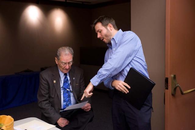 Ames hosts Press Event for talk with STS-135 Astronauts onboard the Space Shuttle,  Jack Boyd (seated) and John Yembrick, PAO chief go over interview points.