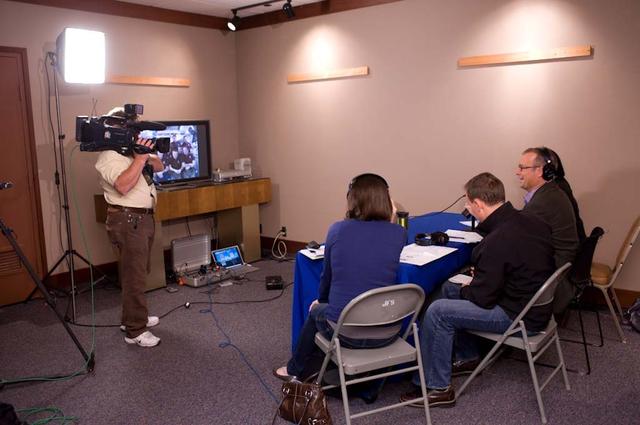 Ames hosts Press Event for talk with STS-135 Astronauts onboard the Space Shuttle. Bob Redell KNTV NBC Channel-11 (far left) and Matt Bigler, KCBS - Radio (CBS-Bay Area) middle participate in live interview with the Astronauts onboard STS-135  (in the near frame Rachel Hover, PAO officer monitors interview) NBC cameraman documents event.