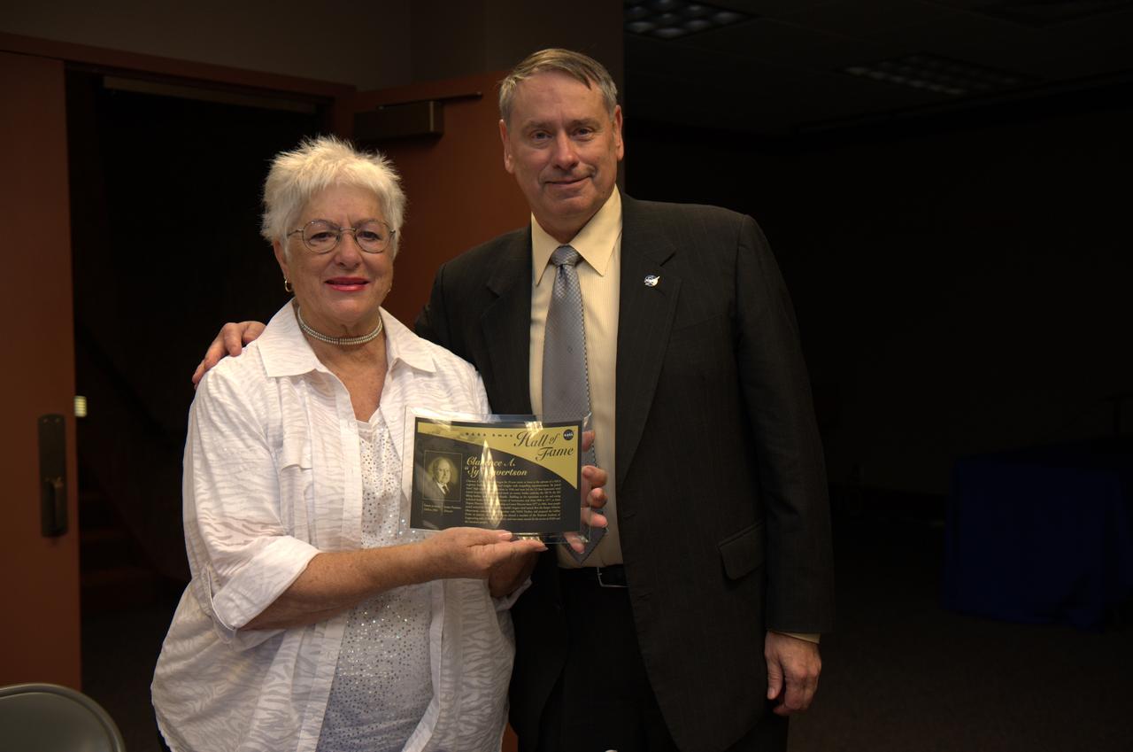 Ames officially renames its Main Auditorium (N201) in memory of former Ames Center Director Clarence 'Sy' Syvertson 1977 to 1984. Shown here on right is Mrs. JoAnn Syvertson holding the plaque from Syvertson induction into the Ames Hall of Fame in 2000 and Ames Center Director S. Pete Worden 2006 -