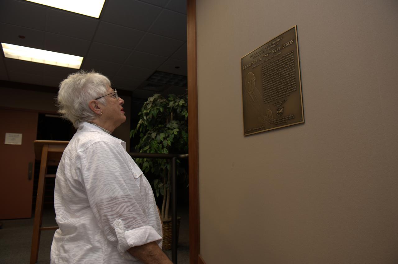 Dedication of the Clarence A. 'Sy' Syvertson Auditorium On July 15, 2011, Ames officiclly renamed its Main Aduitorium (N201) in memory of former Ames Center Director Clarence 'Sy' Syvertson. Syvertson served as Ames Center Director from 1977 to 1984 and passed away Sept 13, 2010. He began his 35-year career at Ames in 1948 and in addition to being Center Director, he also served as Ames' Director of Astronautics and Deputy Director. Syvertson was instrumental in remodeling the auditorium and it is entirely fitting that it be named in his honor. Seen here from left to right are: Syvertson's wife Joann; Ames Center Director S. Pete Worden ; his daughter Lynn and Jack Boyd, senior advisor to the center director. Mrs. JoAnn Syvertson looks a dedication plaque placed in honor of her husband.