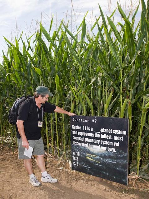 Space Farm 7 Program; NASA Day at the Dell'osso Family Farm, Lathrop,CA for the opening of the Kepler Corn Maze. Lots of fun activities were available and Kepler scientists gave talks and hands on demos to the audience of kids and adults alike to better understand Kepler and it's mission.  Eric James, Ames photographer stops to read the Kepler maze know you mission sign.  Photo take by Maria James.