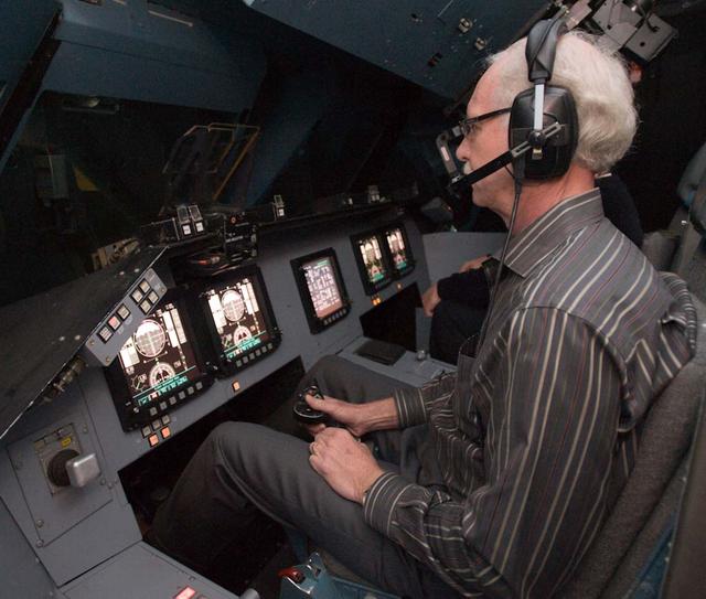 Capt. Chesley 'Sully' Sullenberger visits Ames Vertical Motion Simulator facility and takes a 'ride' in the Shuttle Cab (S-cab).