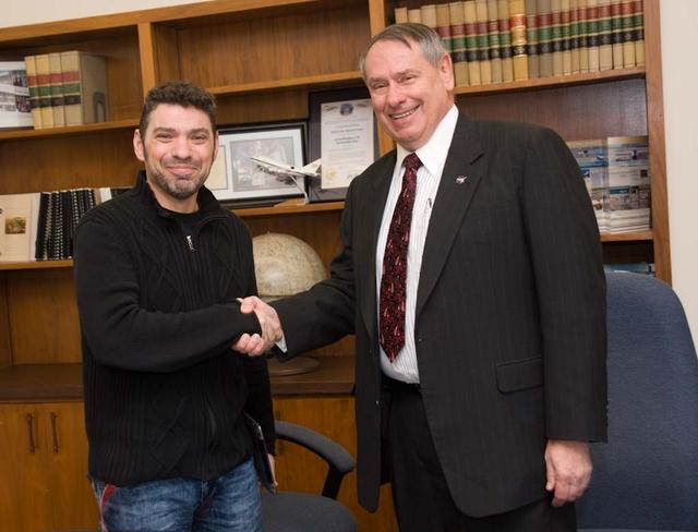 Silicon Valley technology Festival Paco Rafageles, left and Dr Pete Worden, Director Ames Research Center, right sign documents seal it with a hand shake.