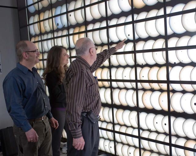 Kepler Program VIP's from left Jon Jenkins, Natalie Batalha, and Bill Borucki pointing at the NASA Ames Hyperwall in the NAS (NASA Advanced Supercomputing) facility filled with exo-planets discovered during Kepler Mission. Moffett Field, CA (for aviation week)