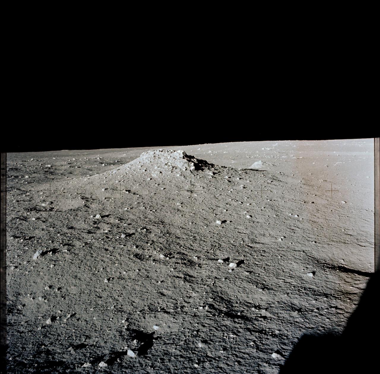 AS12-46-6795 (19-20 Nov. 1969) --- A view of the lunar surface in the vicinity of the Apollo 12 lunar landing site, photographed during the extravehicular activity (EVA) of astronauts Charles Conrad Jr., commander, and Alan L. Bean, lunar module pilot. Conrad and Bean encountered the odd, anthill-shaped mound during their lunar traverse. The two descended in the Apollo 12 Lunar Module (LM) to explore the moon, while astronaut Richard F. Gordon Jr., command module pilot, remained with the Command and Service Modules (CSM) in lunar orbit.