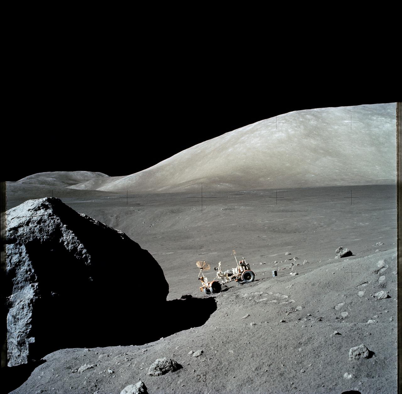 AS17-140-21493 (13 Dec. 1972) --- The Apollo 17 Lunar Roving Vehicle (LRV) is photographed near a large lunar boulder during the third Apollo 17 extravehicular activity (EVA) at the Taurus-Littrow landing site. About half of the boulder is captured in this scene, photographed by astronaut Eugene A. Cernan, mission commander. While astronauts Cernan and Harrison H. Schmitt descended in the Lunar Module (LM) "Challenger" to explore the lunar surface, astronaut Ronald E. Evans, command module pilot, remained with the Command and Service Modules (CSM) in lunar orbit.