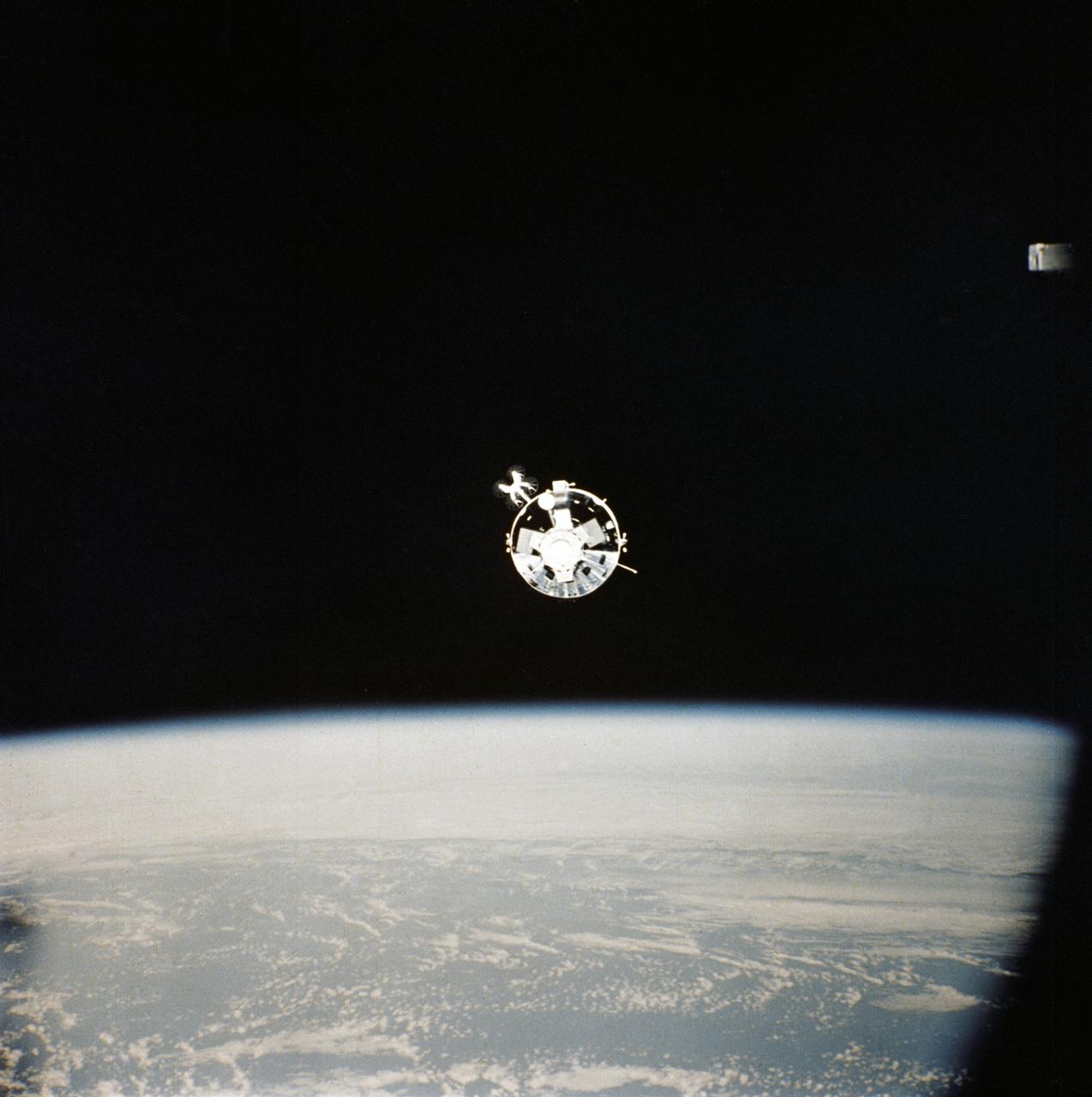 AST-32-2675 (17-19 July 1975) --- The American Apollo spacecraft as seen in Earth orbit from the Soviet Soyuz spacecraft during the joint U.S.-USSR Apollo-Soyuz Test Project mission. The Command/Service Module and Docking Module are contrasted against a black-sky background. This is a "head on" view of the Apollo. The horizon of Earth is below. This picture was furnished by the USSR in an exchange of photography taken during the ASTP flight. The American and Soviet spacecraft were joined together in space for approximately 47 hours on July 17-18-19, 1975. Note the docking mechanism on the Docking Module. PHOTO COURTESY: USSR ACADEMY OF SCIENCES