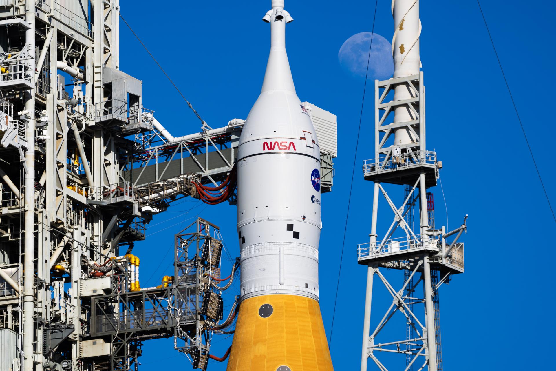 The Moon is seen shining over the SLS (Space Launch System) and Orion spacecraft, atop the mobile launcher on January 28, 2026. The rocket is currently at Launch Pad 39B at NASA’s Kennedy Space Center in Florida, as teams are preparing for a wet dress rehearsal to practice timelines and procedures for the launch of Artemis II. 508 Description:The Moon is seen shining over the SLS (Space Launch System) and Orion spacecraft, atop the mobile launcher on January 29, 2026. The rocket is currently at Launch Pad 39B at NASA’s Kennedy Space Center in Florida, as teams are preparing for a wet dress rehearsal to practice timelines and procedures for the launch of Artemis II.