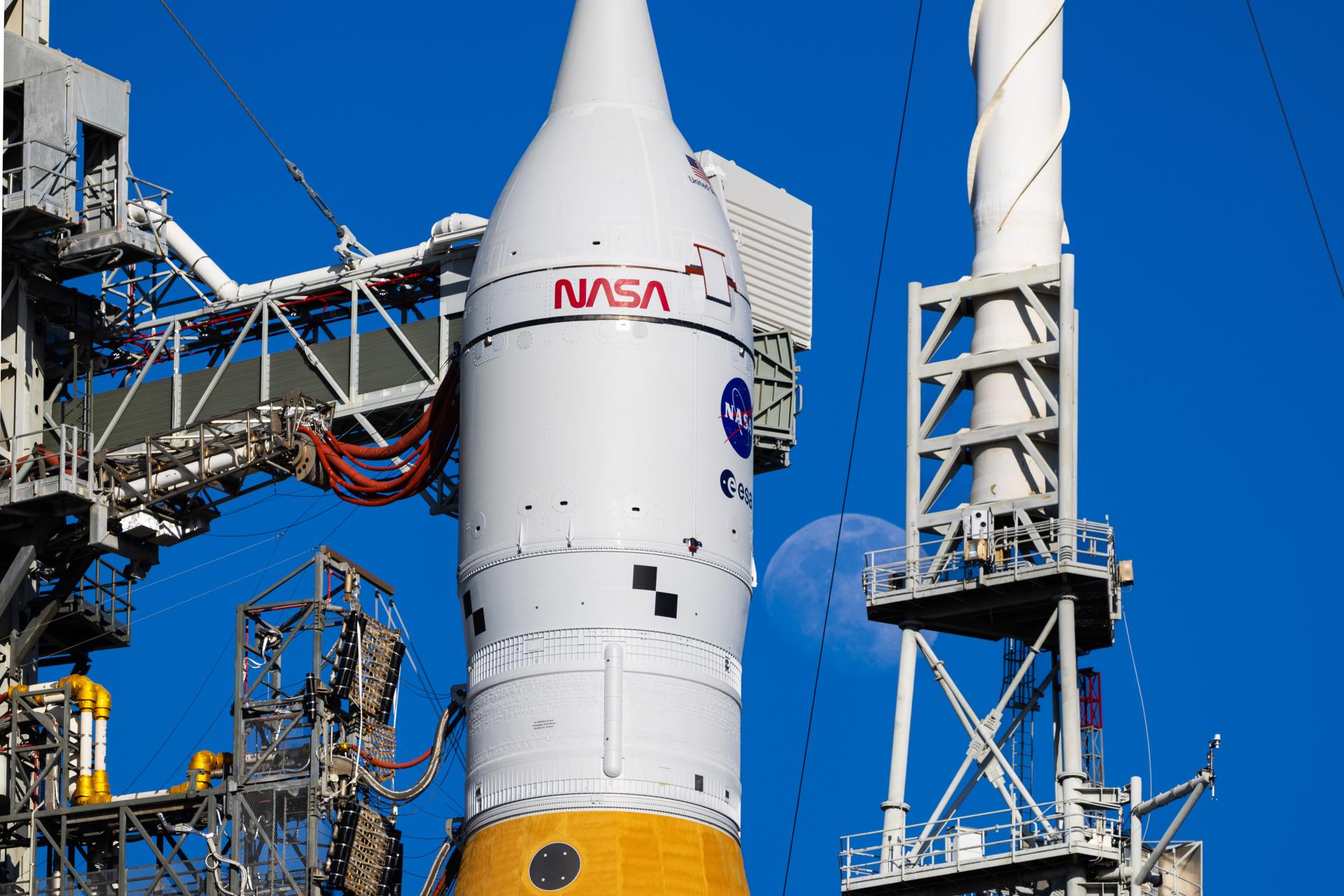 The Moon is seen shining over the SLS (Space Launch System) and Orion spacecraft, atop the mobile launcher on January 29, 2026. The rocket is currently at Launch Pad 39B at NASA’s Kennedy Space Center in Florida, as teams are preparing for a wet dress rehearsal to practice timelines and procedures for the launch of Artemis II.