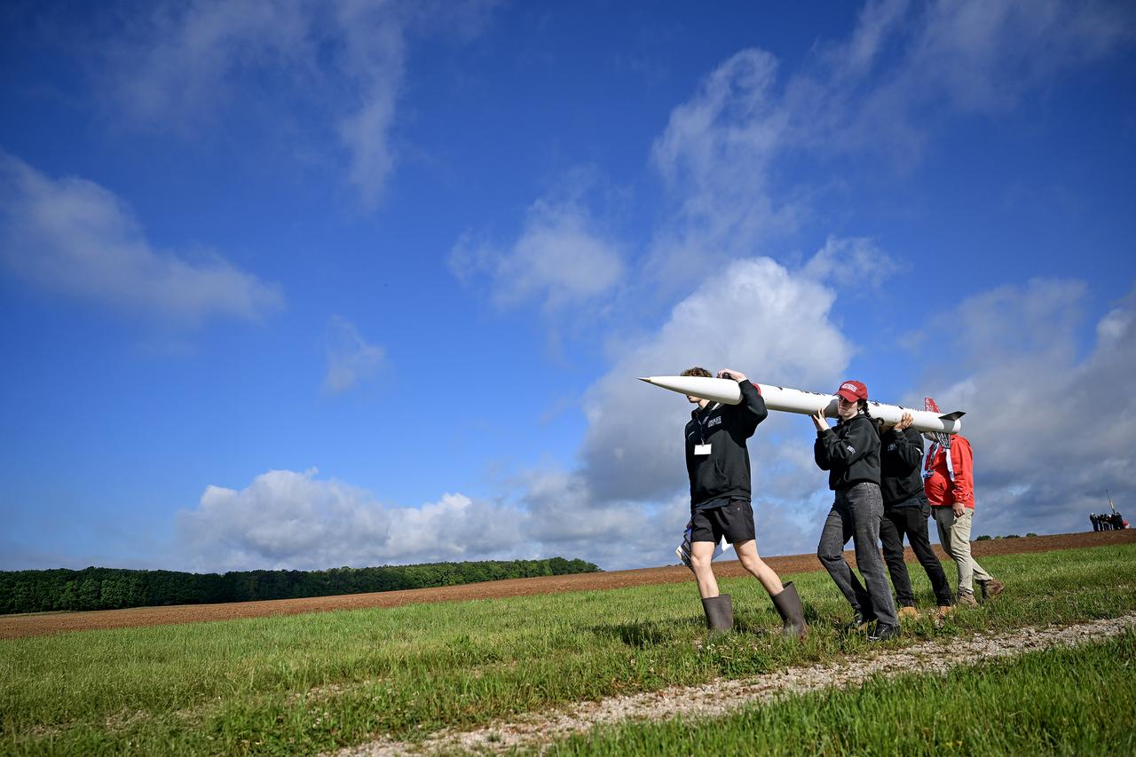 Students from the University of Massachusetts Amherst team carry their high-powered  rocket toward the launch pad at NASA’s 2025 Student Launch launch day competition in Toney, Alabama, on May 4, 2025. More than 980 middle school, high school, and college students from across the nation launched more than 40 high-powered amateur rockets just north of NASA’s Marshall Space Flight Center in Huntsville, Alabama. This year marked the 25th anniversary of the competition. To compete, students follow the NASA engineering design lifecycle by going through a series of reviews for nine months leading up to launch day. Each year, a payload challenge is issued to the university teams, and this year’s task focused on communication.  Teams were required to have “reports” from STEMnauts, non-living objects inside their rocket, that had to relay real-time data to the student team’s mission control. This Artemis Student Challenge took inspiration from the agency’s Artemis missions, where NASA will send astronauts to explore the Moon for scientific discovery, economic benefit, and to build the foundation for the first crewed missions to Mars. To learn more, visit: www.nasa.gov/studentlaunch.  