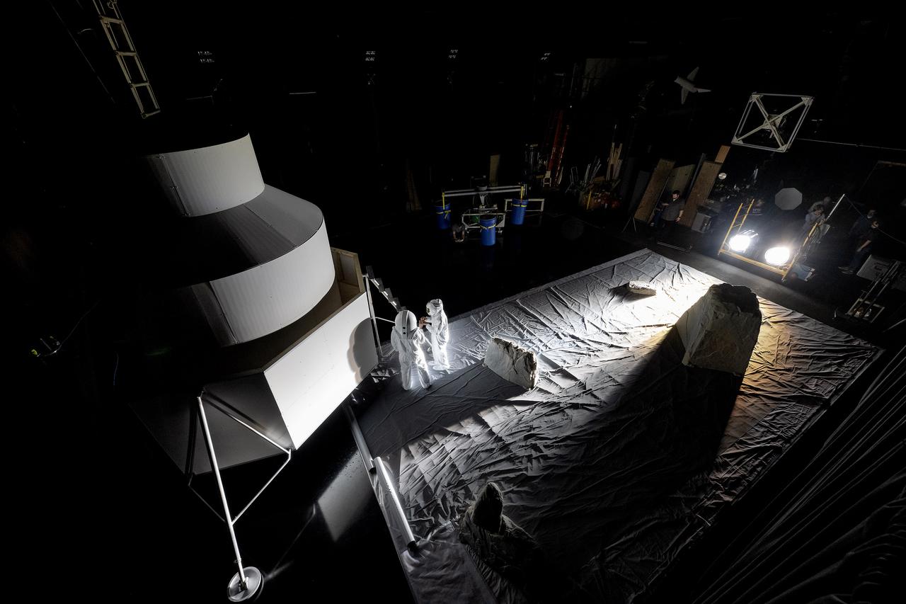 These photos show how teams at NASA’s Marshall Space Flight Center in Huntsville, Alabama, are using the Flat Floor Facility (Building 4619) to understand the lunar lighting environment in preparation for the Artemis III crewed lunar landing mission, slated for 2027. The Flat Floor Facility is an air-bearing floor, providing full-scale simulation capabilities for lunar surface systems by simulating zero gravity in two dimensions. Wearing low-fidelity materials, test engineers can understand how the extreme lighting of the Moon’s South Pole could affect surface operations during Artemis III. High-intensity lights are positioned at a low angle to replicate the strong shadows that are cast across the lunar South Pole by the Sun. Data and analysis from testing at NASA Marshall are improving models Artemis astronauts will use in preparation for lander and surface operations on the Moon during Artemis III. Testing in the facility is also helping cross-agency teams evaluate various tools astronauts may use. NASA Marshall manages the Human Landing System (HLS) Program. For more information, contact NASA Marshall’s Office of Communications at 256-544-0034.