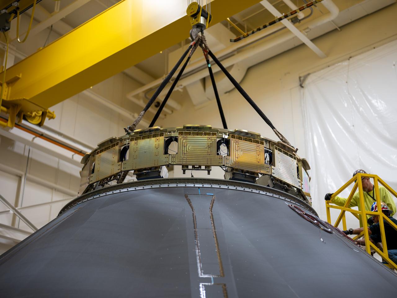 These photos and videos show how NASA manufactured and prepared to transport the payload adapter in February inside Building 4708 at NASA’s Marshall Space Flight Center in Huntsville, Alabama.  Prior to moving the hardware for testing, teams installed the New Explorations Secondary Transport component, called the NEST, into the top of the engineering development unit. The NEST component will allow the hardware to hold a series of secondary payloads, or small satellites. The cone-shaped payload adapter is about 8.5 feet tall and features two metal rings and eight composite panels. The adapter, which will debut on NASA’s Artemis IV mission, is an evolution from the Orion stage adapter used in the Block 1 configuration of the rocket for the first three Artemis missions. It will be housed inside the universal stage adapter atop the rocket’s more powerful in-space stage, called the exploration upper stage. The payload adapter, like the launch vehicle stage adapter and the Orion stage adapter, is fully manufactured and tested at Marshall, which manages the SLS Program.  NASA is working to land the first woman, first person of color, and its first international partner astronaut on the Moon under Artemis. SLS is part of NASA’s backbone for deep space exploration, along with the Orion spacecraft and Gateway in orbit around the Moon and commercial human landing systems, next-generational spacesuits, and rovers on the lunar surface. SLS is the only rocket that can send Orion, astronauts, and supplies to the Moon in a single launch.