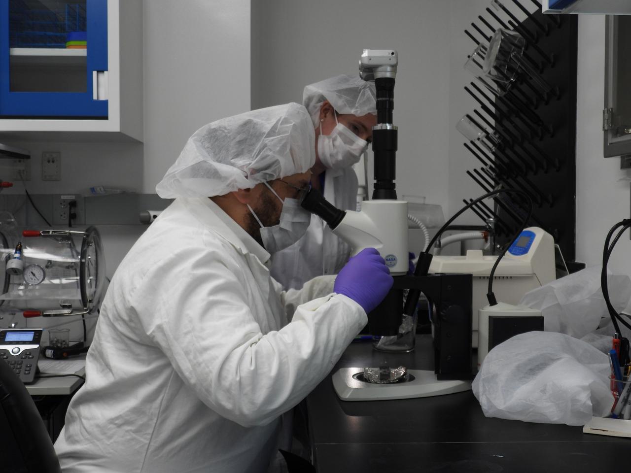 Jason Dworkin, project scientist for NASA's OSIRIS-REx (Origins, Spectral Interpretation, Resource Identification, and Security – Regolith Explorer) mission, examines a portion of the asteroid Bennu sample delivered to Earth in a laboratory at the agency's Goddard Space Flight Center in Greenbelt, Maryland.