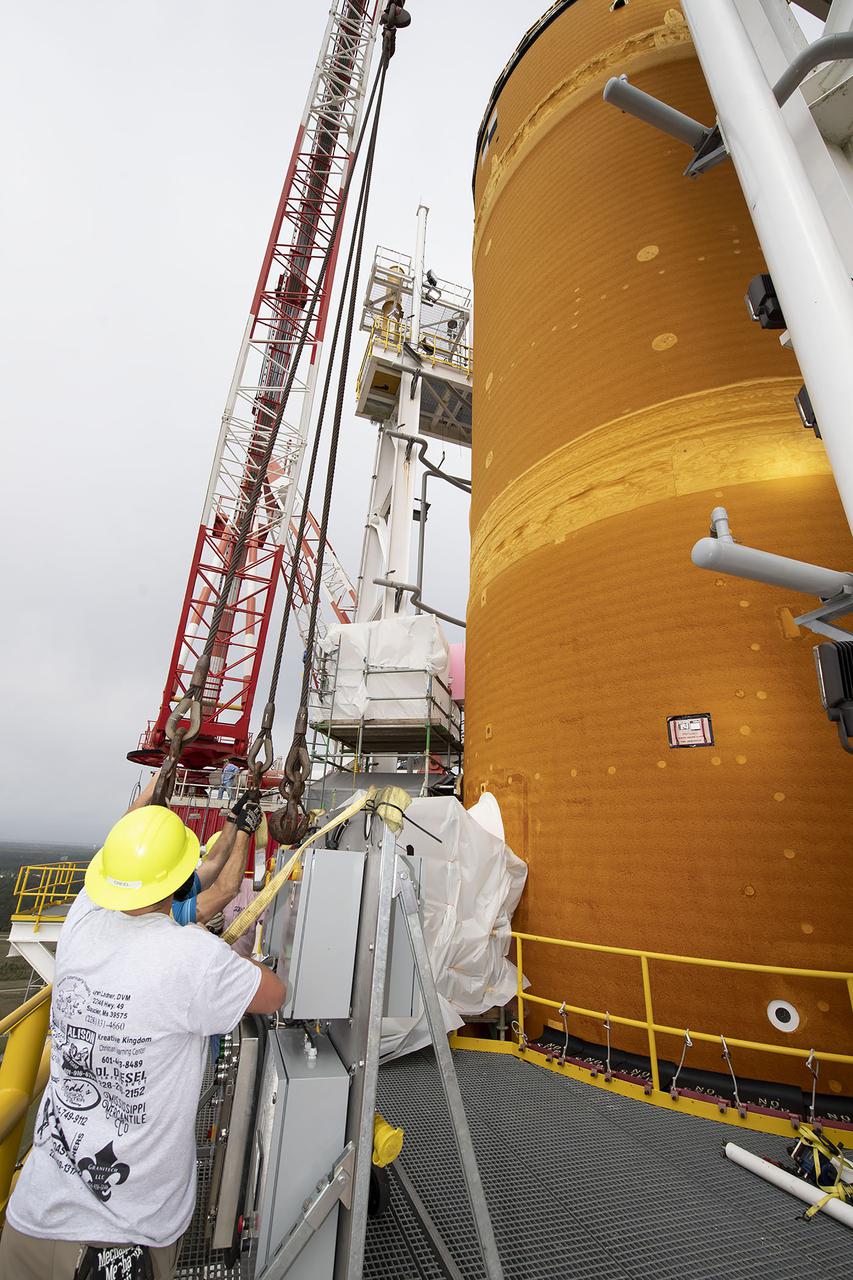 Team members at NASA’s Stennis Space Center near Bay St. Louis, Mississippi, complete refurbishment work on the first core stage of the agency’s Space Launch System (SLS) rocket. The work followed a successful hot fire of the stage and its four RS-25 engines March 18. The hot fire marked the culmination of a yearlong Green Run series of tests of the stage and its integrated systems. Following refurbishment work, the core stage will be removed from the test stand and transported to Kennedy Space Center in Florida, aboard NASA’s Pegasus barge, shown delivering equipment to the B-2 Test Stand. At Kennedy, the core stage will be integrated with the rest of SLS rocket and prepared for the launch of the Artemis I mission to the Moon.  Photo Credit: NASA