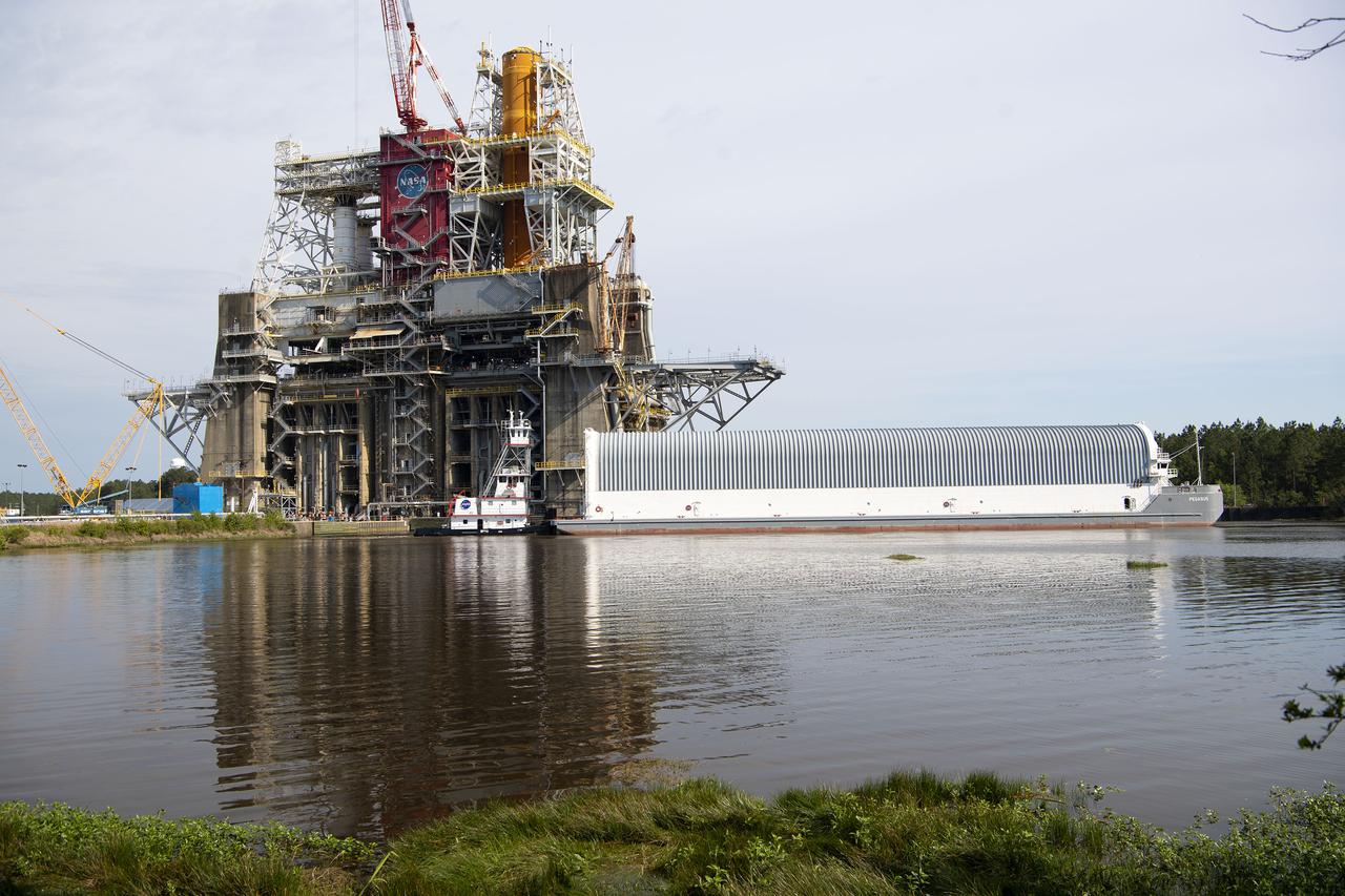 Team members at NASA’s Stennis Space Center near Bay St. Louis, Mississippi, complete refurbishment work on the first core stage of the agency’s Space Launch System (SLS) rocket. The work followed a successful hot fire of the stage and its four RS-25 engines March 18. The hot fire marked the culmination of a yearlong Green Run series of tests of the stage and its integrated systems. Following refurbishment work, the core stage will be removed from the test stand and transported to Kennedy Space Center in Florida, aboard NASA’s Pegasus barge, shown delivering equipment to the B-2 Test Stand. At Kennedy, the core stage will be integrated with the rest of SLS rocket and prepared for the launch of the Artemis I mission to the Moon.  Photo Credit: NASA