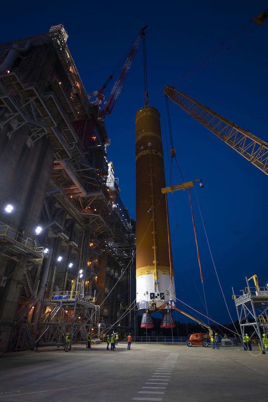 Following a successful Green Run hot fire at NASA’s Stennis Space Center near Bay St. Louis, Mississippi, on March 18, members of a blended team work April 19-20 to remove the first core stage of the agency’s Space Launch System (SLS) rocket from the B-2 Test Stand. The work required crews to lift the core stage from its vertical placement in the stand and lower it to a horizontal position on the B-2 Test Stand tarmac. The stage now will be loaded on NASA’s Pegasus barge for transport to Kennedy, where it will be prepared for launch of the Artemis I mission. Removal of the largest rocket stage ever built by NASA followed completion of a series of eight Green Run tests over the past year. During the Green Run series, teams performed a comprehensive test of the stand’s sophisticated and integrated systems. Photo Credit: NASA