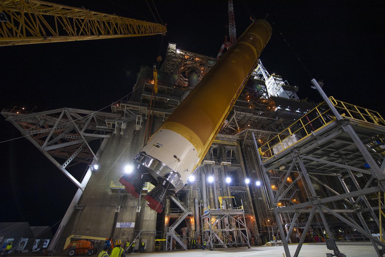 Following a successful Green Run hot fire at NASA’s Stennis Space Center near Bay St. Louis, Mississippi, on March 18, members of a blended team work April 19-20 to remove the first core stage of the agency’s Space Launch System (SLS) rocket from the B-2 Test Stand. The work required crews to lift the core stage from its vertical placement in the stand and lower it to a horizontal position on the B-2 Test Stand tarmac. The stage now will be loaded on NASA’s Pegasus barge for transport to Kennedy, where it will be prepared for launch of the Artemis I mission. Removal of the largest rocket stage ever built by NASA followed completion of a series of eight Green Run tests over the past year. During the Green Run series, teams performed a comprehensive test of the stand’s sophisticated and integrated systems. Photo Credit: NASA