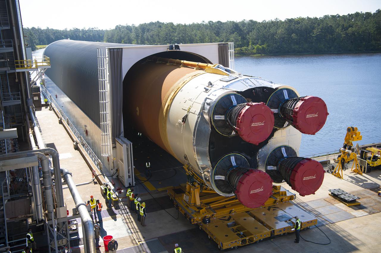 Team members at NASA’s Stennis Space Center near Bay St. Louis, Mississippi, load the first core stage of the agency’s Space Launch System (SLS) rocket on to the agency’s Pegasus barge in preparation for its transport to Kennedy Space Center in Florida. The loading activity followed removal of the stage from the B-2 Test Stand at Stennis on April 19-20, 2021. It comes about a month after NASA conducted a successful hot fire of the stage and its four RS-25 engines on March 18 and after teams completed various refurbishment activities. Once at Kennedy, the will be integrated with the rest of SLS rocket and prepared for the launch of the Artemis I mission to the Moon. Photo Credit: NASA